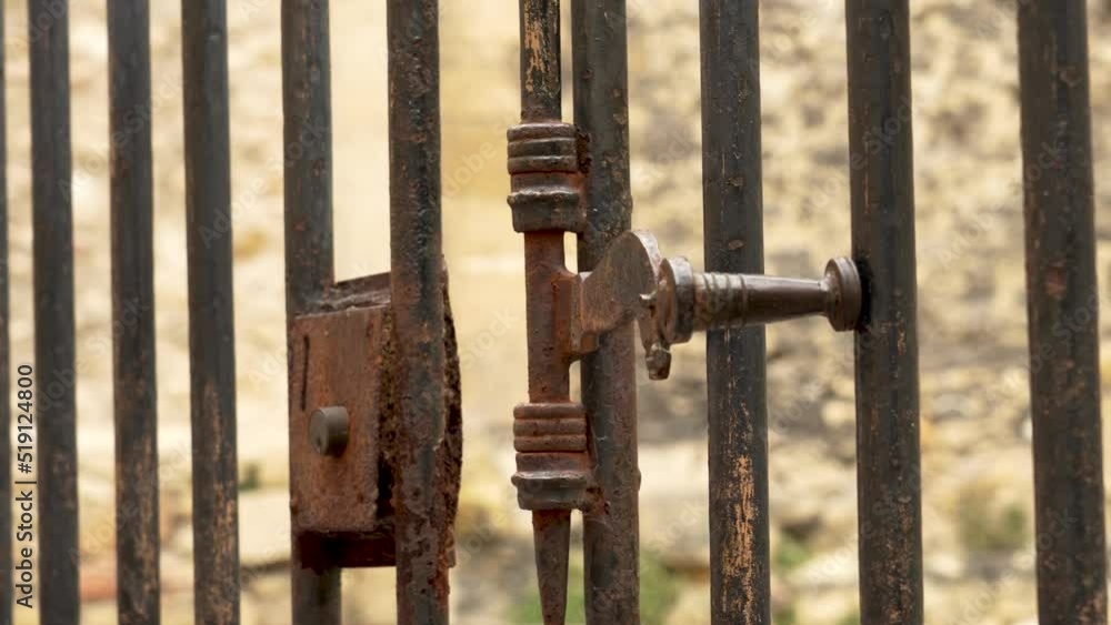 Ancient metal rusty wrought latch. Handle deadbolt of the door of the