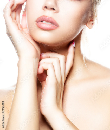 Beauty young woman face with perfect skin, lips, hands near cheek