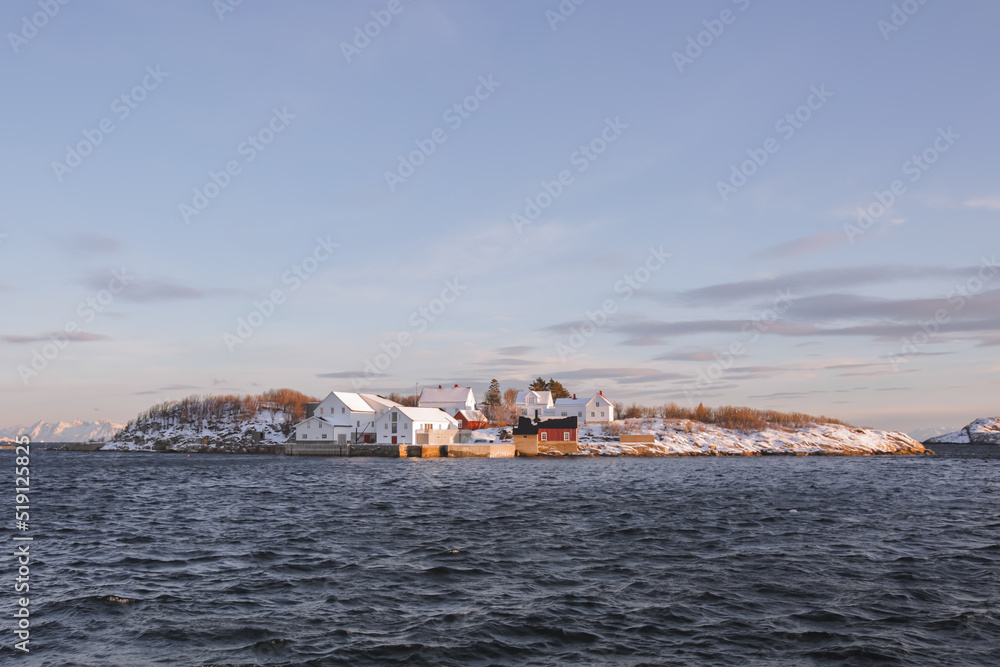 Little artic island with some houses. Cold landscape of northern Norway, the rorbuers arre covered with snow at winter