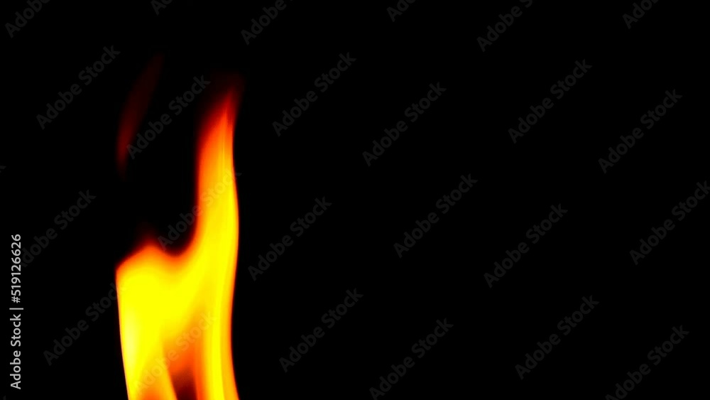 A flame of fire on a black screen. Burning flames isolated on a dark background. A flame of fire on a black screen. Burning flames isolated on a dark background.