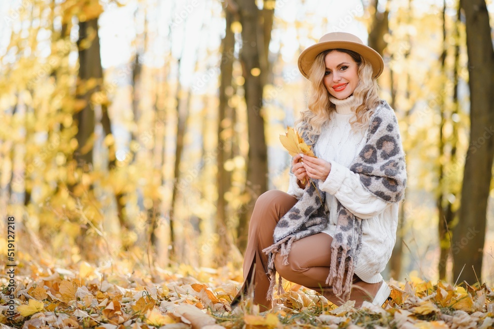 Happy smiling young woman in park on autumn day. Happy smiling young woman in park on autumn day.