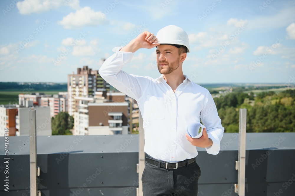 Close up engineers working on a building site holding a blueprints.Engineering and architecture concept Close up engineers working on a building site holding a blueprints.Engineering and architecture concept