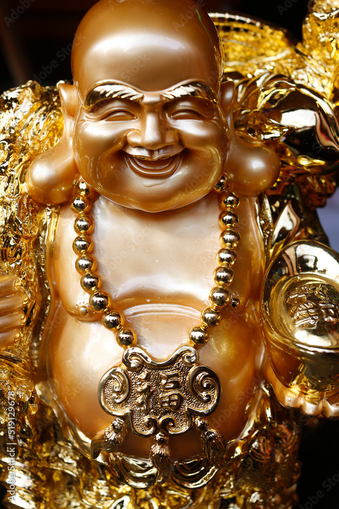 Statue of Ong Dia, the round, happy God of the Earth who symbolizes prosperity