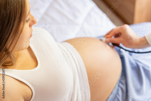 Doctor stethoscope patient pregnancy woman. Medical clinic for pregnant consultant. Doctor examining pregnancy woman belly holding stethoscope. Concept maternity, pregnancy, childbirth.