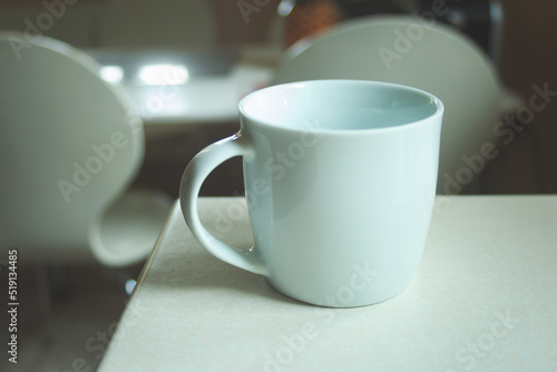 White empty mug standing on the counter