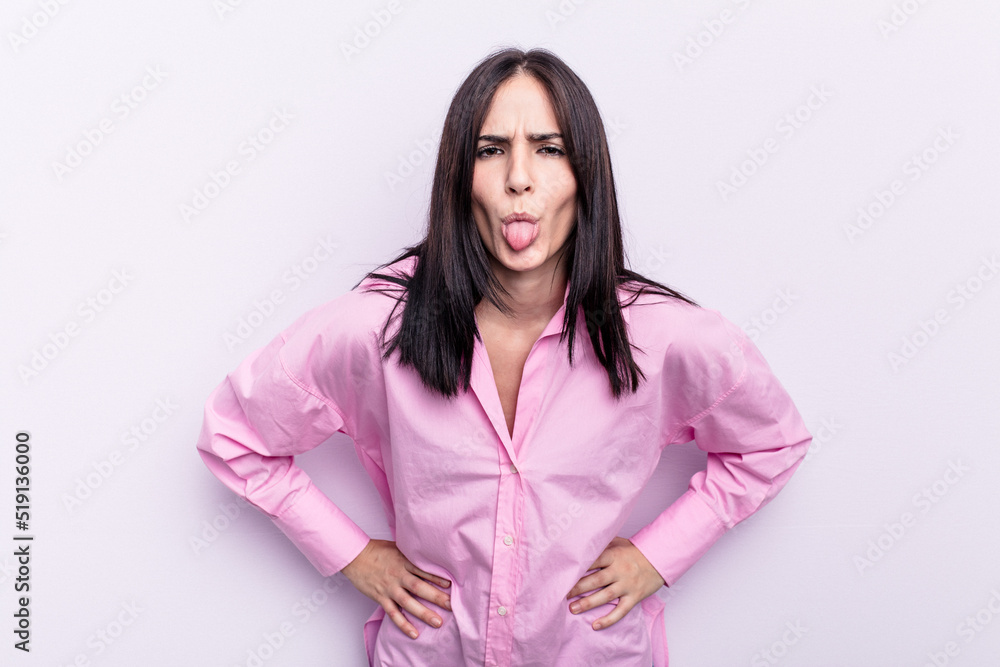 Young caucasian woman isolated on pink background funny and friendly sticking out tongue. Young caucasian woman isolated on pink background funny and friendly sticking out tongue.