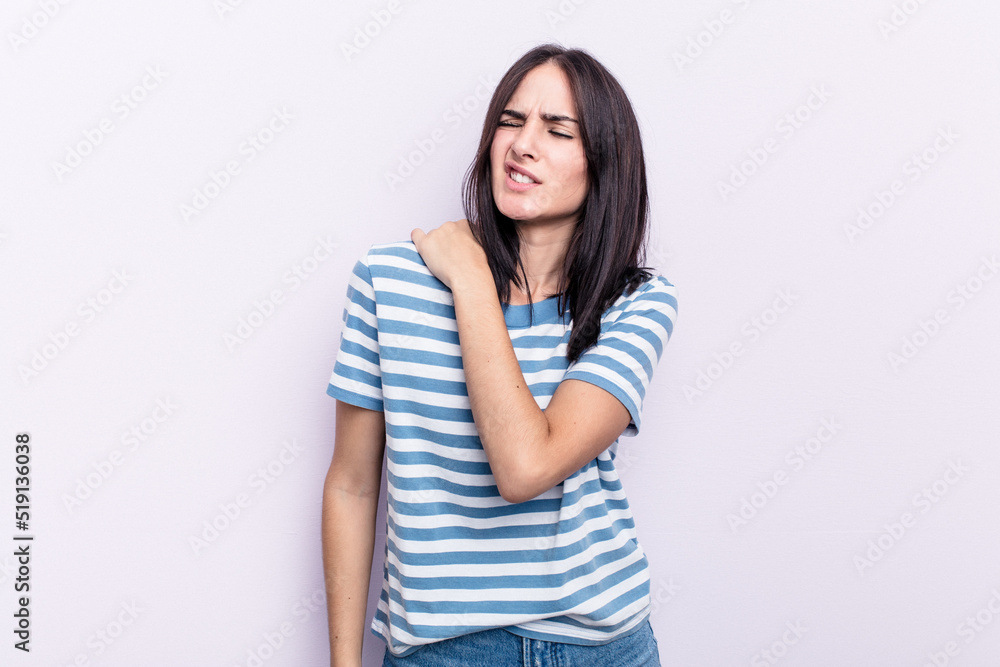 Young caucasian woman isolated on pink background having a shoulder pain. Young caucasian woman isolated on pink background having a shoulder pain.