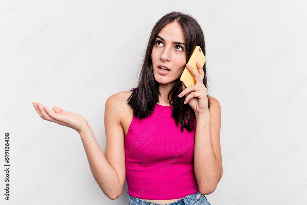 Young caucasian woman holding mobile phone isolated on white background Young caucasian woman holding mobile phone isolated on white background