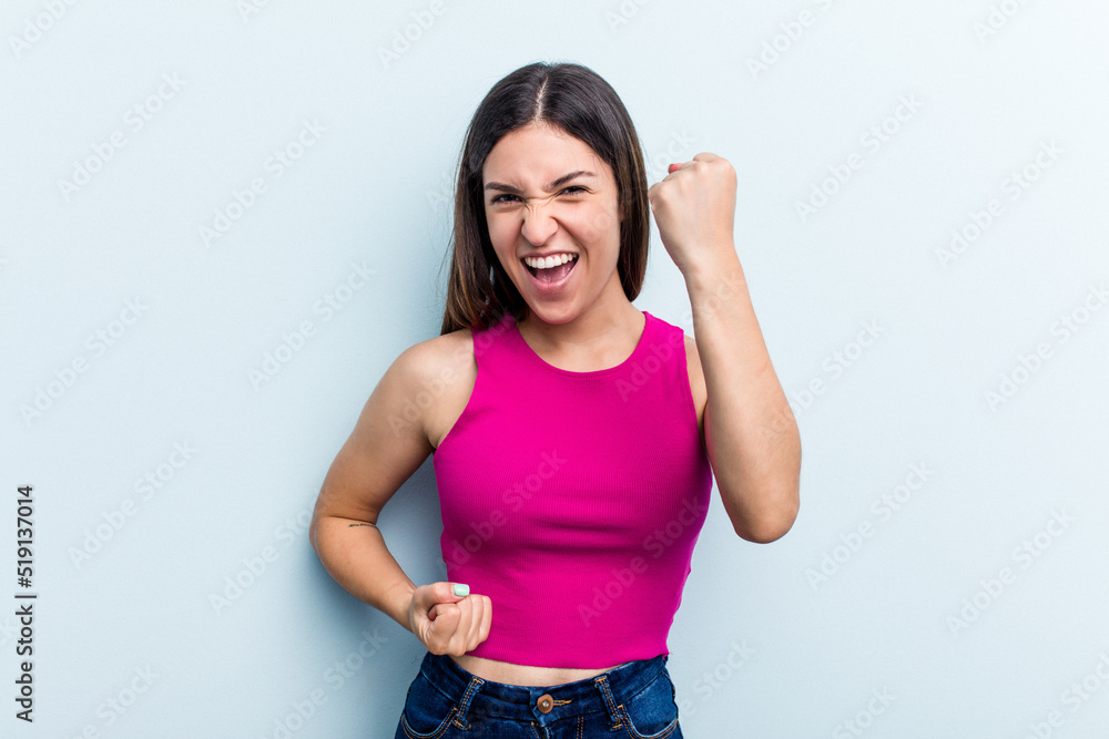 Young caucasian woman isolated on blue background cheering carefree and excited. Victory concept. Young caucasian woman isolated on blue background cheering carefree and excited. Victory concept.