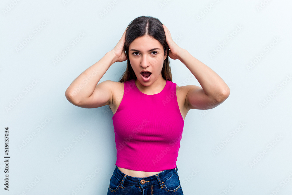 Young caucasian woman isolated on blue background screaming, very excited, passionate, satisfied with something. Young caucasian woman isolated on blue background screaming, very excited, passionate, satisfied with something.