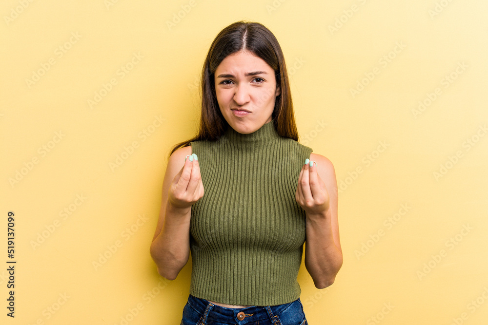 Young caucasian woman isolated on yellow background showing that she has no money. Young caucasian woman isolated on yellow background showing that she has no money.