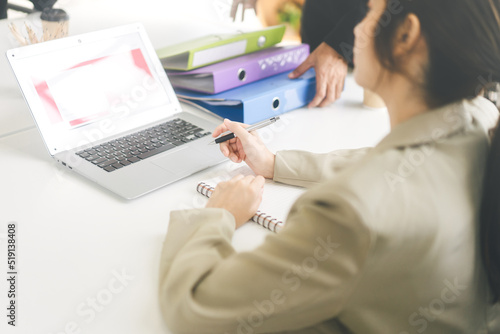 Back shoulder view of business woman meeting in boardroom workplace on table with laptop