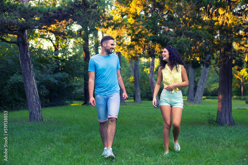 Young couple walking in the park on a beautiful summer day