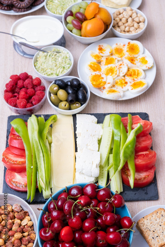Healthy breakfast concept with fresh vegetables, eggs, nuts and fruits