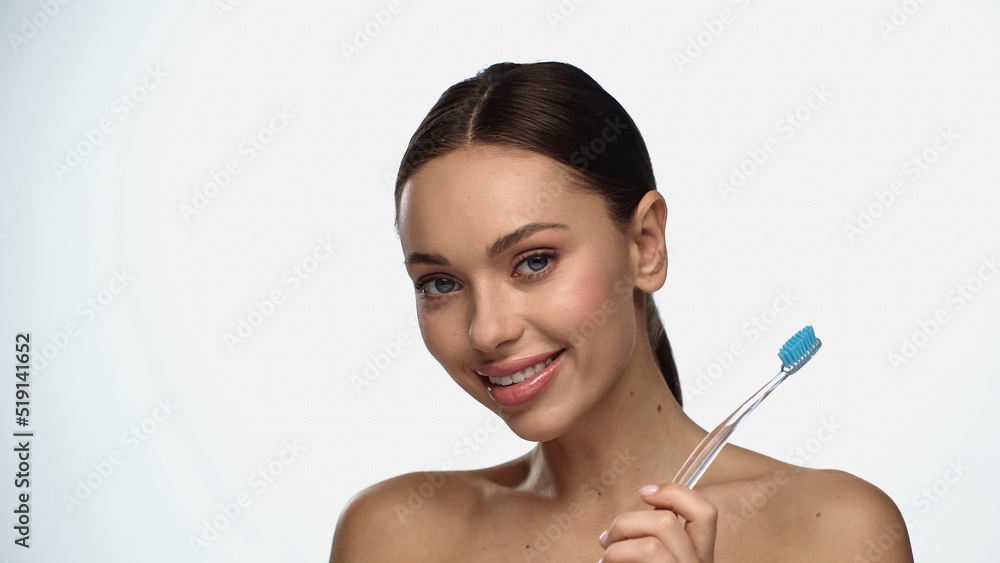 happy young woman smiling while holding toothbrush isolated on white. happy young woman smiling while holding toothbrush isolated on white.