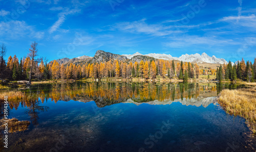 Autumn alpine mountain lake near San Pellegrino Pass, Trentino, Dolomites Alps, Italy.