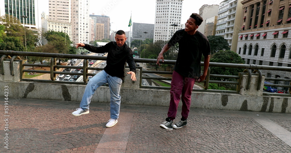 Obraz premium Happy hispanic and black African man dancing in city