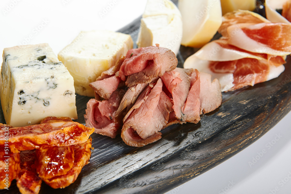 Cheese plate with meat and grapes