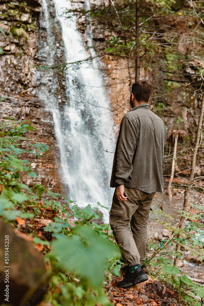 young strong man hiker looking the waterfall young strong man hiker looking the waterfall