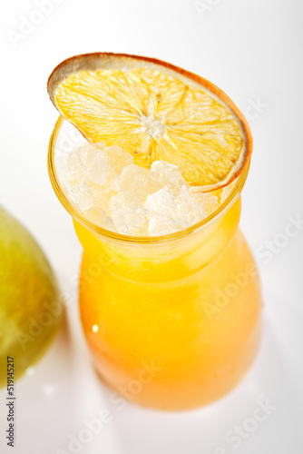 Kiwi and orange fruit lemonade glasses close up