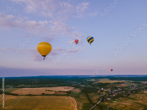 view of air balloon with basket flies on sunset