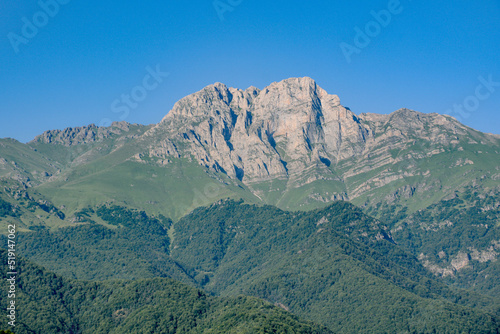 Mountain and amazing nature. Peak of the mountain. Top of Mount Khustup. Blue sky and beautiful mountain photo