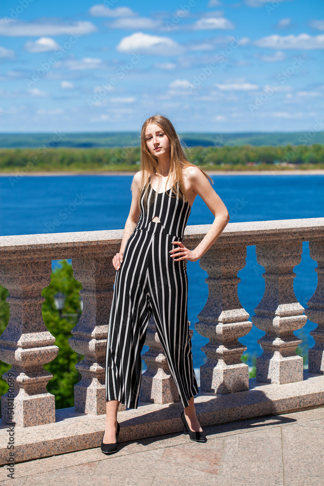 Young blonde girl in a striped jumpsuit