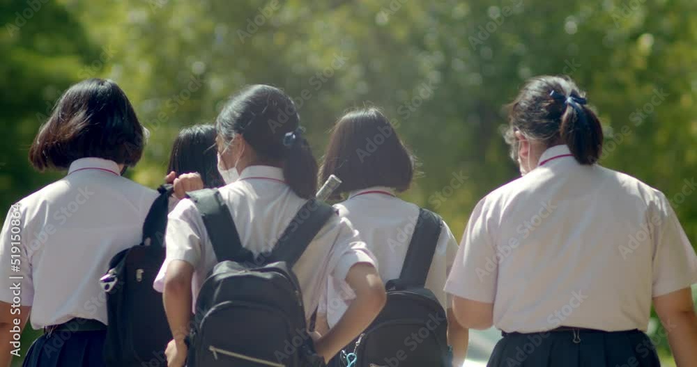 Slow motion back view of the Asian high school students in white ...