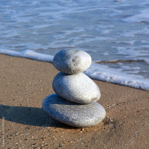 Spa background with zen stones on beach.