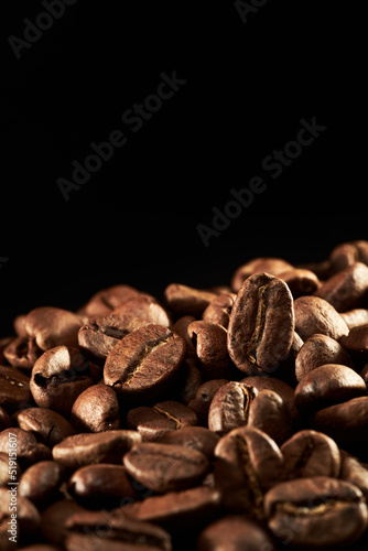 Roasted coffee beans isolated close up on black background, clipping path