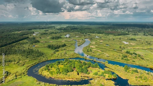 Timelapse Dronelapse Hyperlapse Aerial View Spring Forest Woods And Curved River Marsh. Springtime Landscape. Top View From High Attitude In Summer Season. Drone View, Hyperlapse. Bird's Eye View. 4K photo