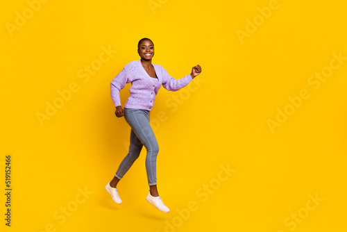 Full size profile photo of overjoyed energetic person running empty space isolated on yellow color background