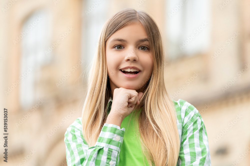 Portrait of happy teen girl smiling with chin on hand blurry outdoors Portrait of happy teen girl smiling with chin on hand blurry outdoors