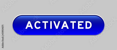 Blue color capsule shape button with word activated on gray background