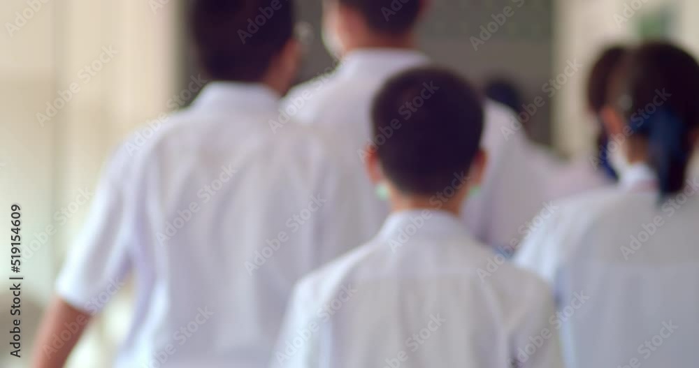 Slow motion scene of Asian high school students in white school uniforms walk on the the corridors of the building while changing their subjects. Slow motion scene of Asian high school students in white school uniforms walk on the the corridors of the building while changing their subjects.