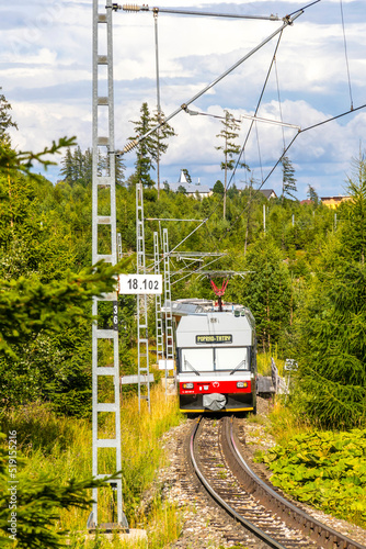 High Tatras, Slovakia - July 2018: Tatra Electric Railways (TEZ-TER) train (also known as "Tatra tram") goes through the forest near Tatranska Polianka stop in High Tatras mountains, Slovakia © katatonia
