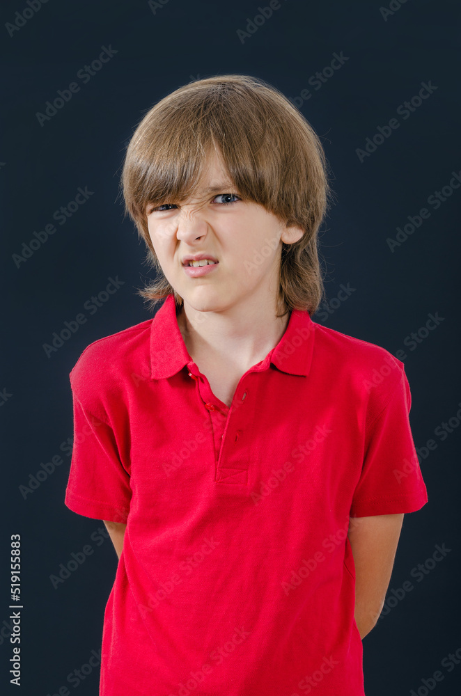 Portrait of kid with an evil look and wrinkle your nose Portrait of kid with an evil look and wrinkle your nose