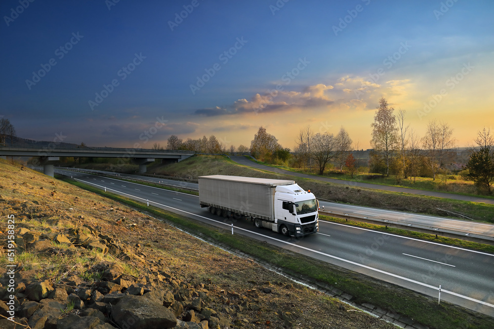 Landscape with a moving truck on the highway.