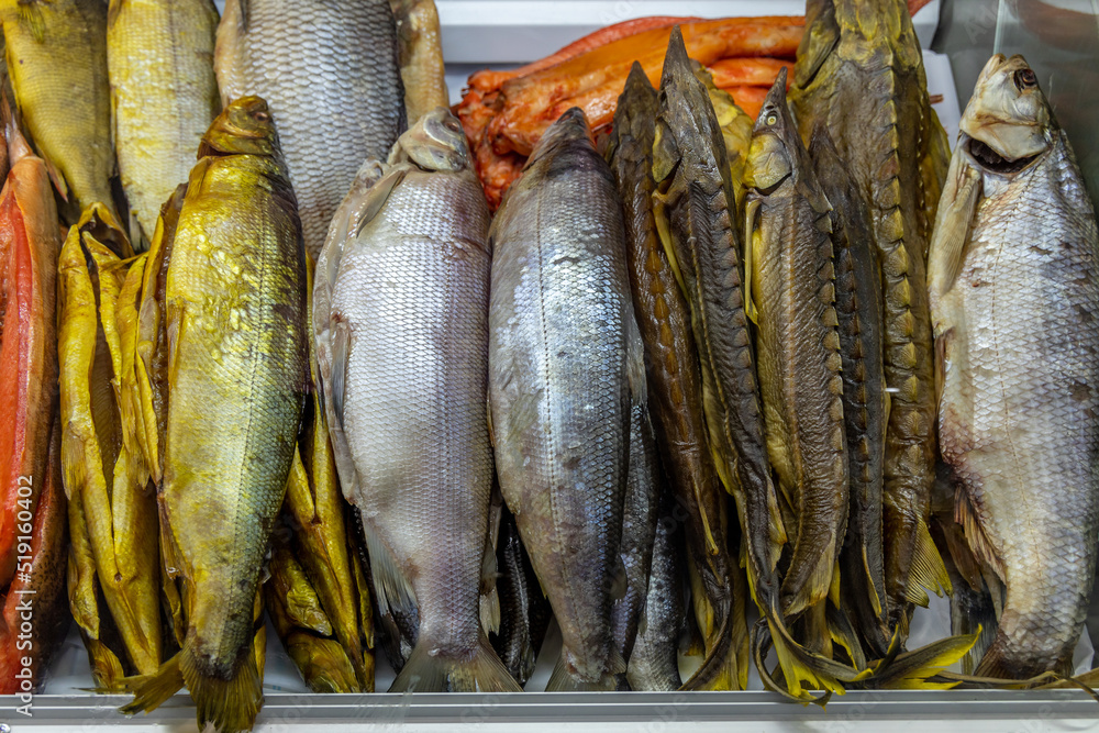 Fototapeta premium Salted fish and cold smoked fish on counter in store