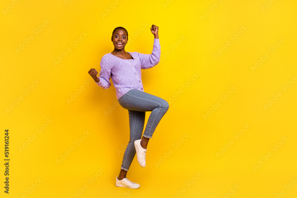Full size photo of astonished delighted girl raise fists success luck isolated on yellow color background