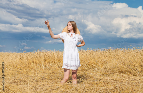 Young blonde model in wheat field © Andrey_Arkusha
