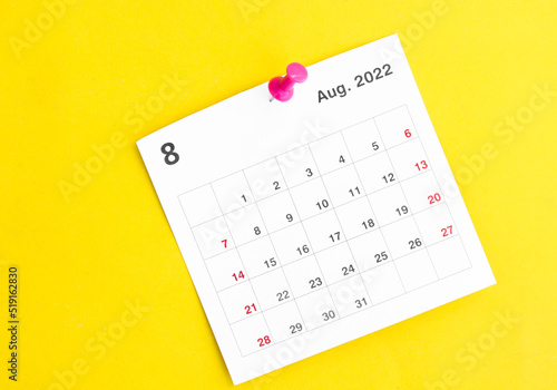 calendar august2023 and wooden pin on yellow background