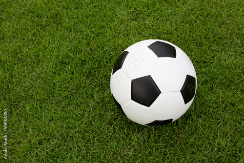 classic football on green grass , soccer ball on field