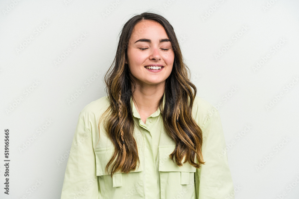 Young caucasian woman isolated on white background laughs and closes eyes, feels relaxed and happy.