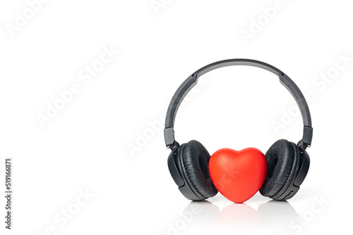 Black wireless headphones with red heart isolated on white background. Listen to your heart music of love. Copy space.