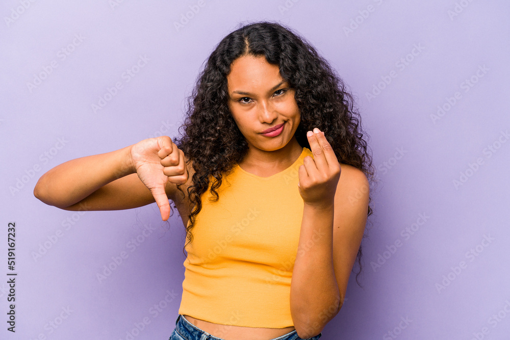 Young hispanic woman isolated on purple background showing that she has no money. Young hispanic woman isolated on purple background showing that she has no money.
