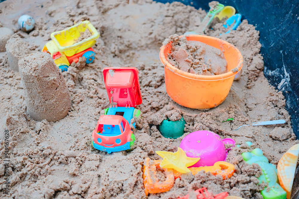 Sand with toys in the sand box for kids playful concept. Holiday activity concept. Bucket and spade Sand with toys in the sand box for kids playful concept. Holiday activity concept. Bucket and spade