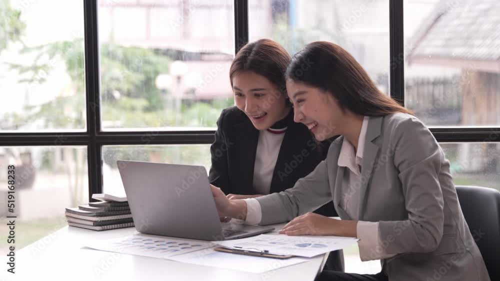 Exciting successful Asian businesswoman Excited to win with a laptop in the office at work. Exciting successful Asian businesswoman Excited to win with a laptop in the office at work.