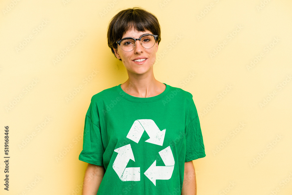 Young recycler caucasian woman isolated on yellow background Young recycler caucasian woman isolated on yellow background happy, smiling and cheerful.