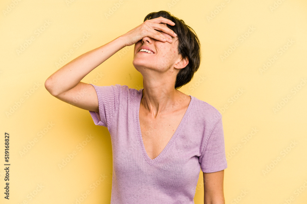 Young caucasian woman with a short hair cut isolated laughs joyfully keeping hands on head. Happiness concept. Young caucasian woman with a short hair cut isolated laughs joyfully keeping hands on head. Happiness concept.